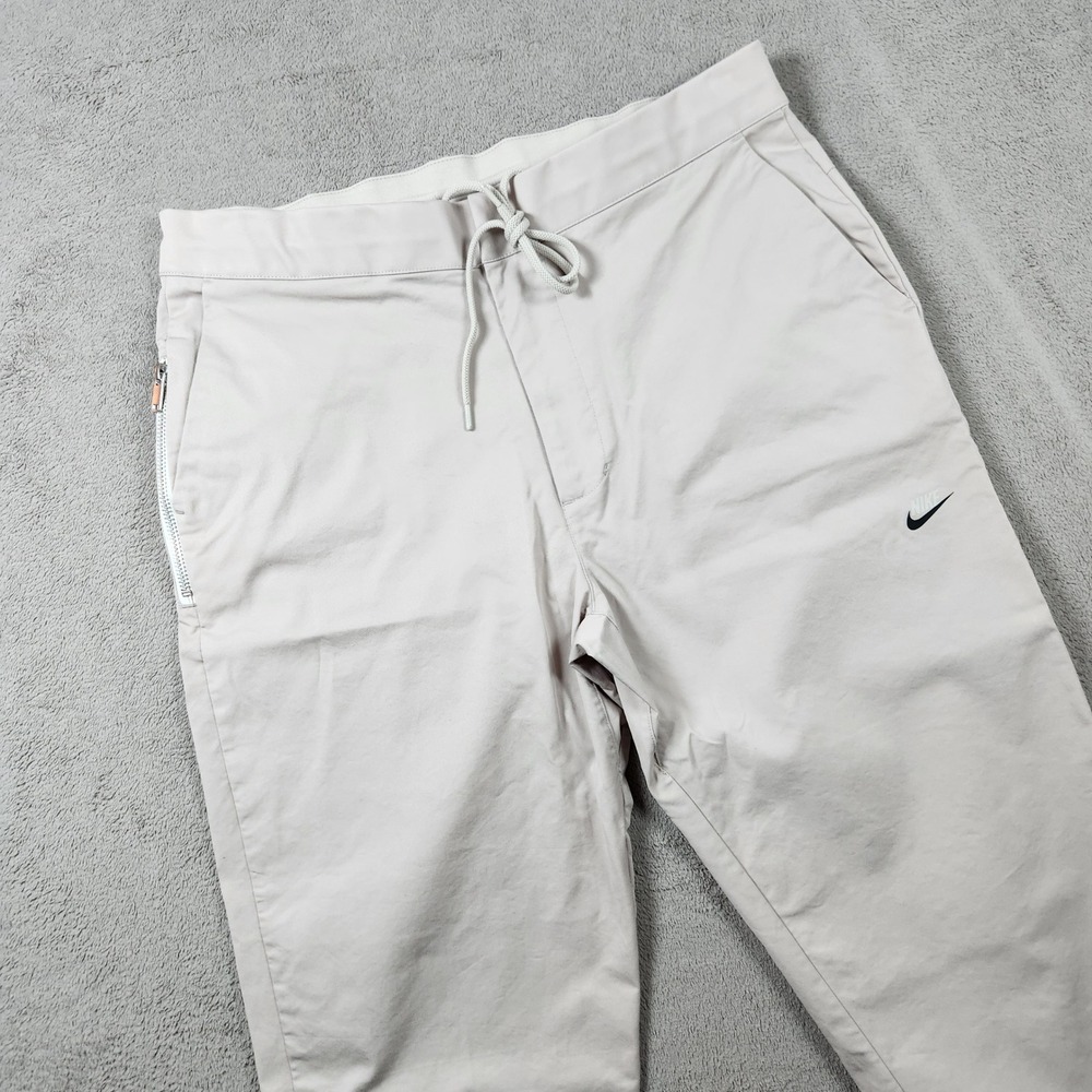 Nike Tech Pack Unlined Commuter Pants Mens size 34 Light Bone Beige DD7032-238